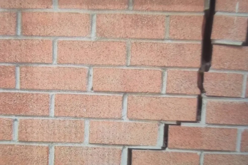 Stepped masonry crack — movement patterns inspectors measure and report